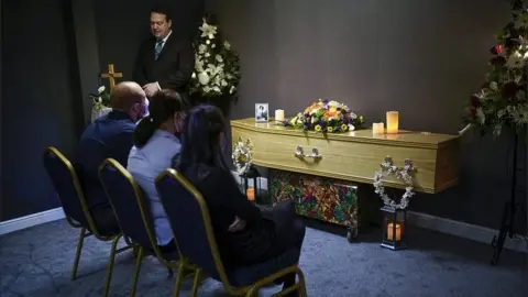 Getty Images Mourners at a funeral