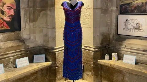 Natalie Malcolm/BBC Dress made from Covid-19 vaccine lids