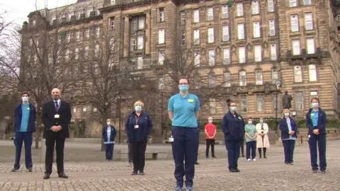 Staff gather for the minute's silence outside Glasgow Royal Infirmary
