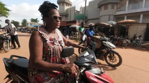 Getty Images A woman on a motorbike in Ouagadougou, Burkina Faso - Tuesday 12 July 2022