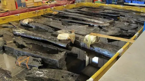 Newport Museums and Heritage Service Planks of wood in a tank of wax