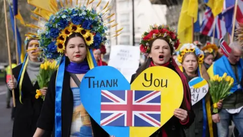 PA Media Some of the people taking part in the march to Trafalgar Square to mark second anniversary of Russia invading Ukraine