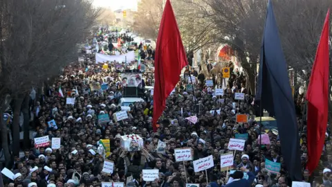 AFP Iranian pro-government supporters march during the funeral of a young member of the Revolutionary Guards, Sajjad Shahsanai, in the city of Najafabad, west of Isfahan, on Wednesday