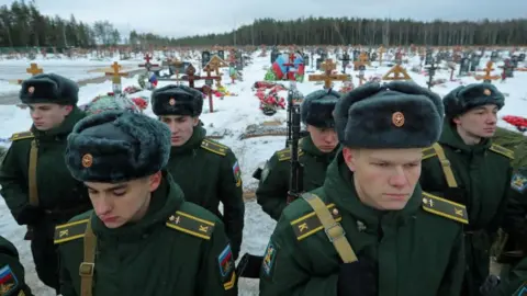 Reuters Cadets of a military academy attend the funeral of Dmitry Menshikov, a mercenary for the private Russian military company Wagner Group, killed during the military conflict in Ukraine, in the Alley of Heroes at a cemetery in Saint Petersburg,