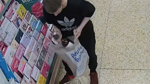 Joshua Turner stealing alcohol from a supermarket.