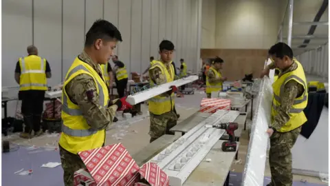 Getty Images Military personnel helping to build the NHS Nightingale Hospital