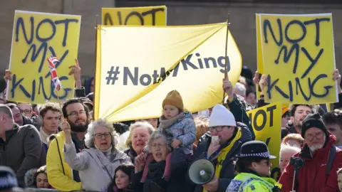 PA Media People protest ahead of King Charles III and Queen Consort attending the Royal Maundy Service at York Minster