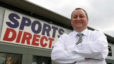 PA Mike Ashley and Sports Direct store