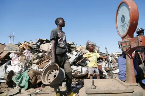 EPA People at a scrap metal outlet in Harare, Zimbabwe - Friday 8 July 2022