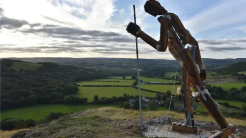 Dafydd Wyn Morgan Hilltop statue overlooking the landscape below