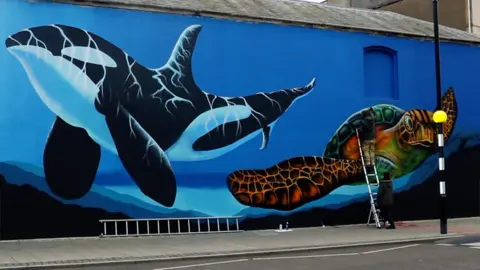 Mural showing orca and turtle