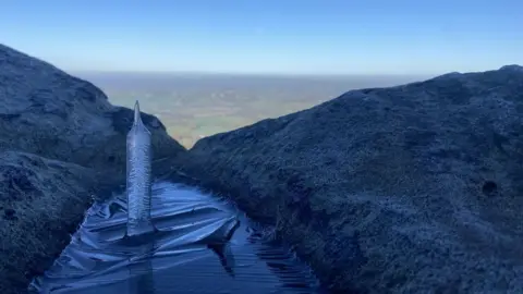 Kayla Ann Newton Ice spike sticking upwards from icy water