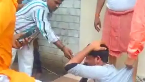 SHURAIH NIYAZI/BBC A screen grab of the viral video showing a bangle-seller being assaulted in Indore