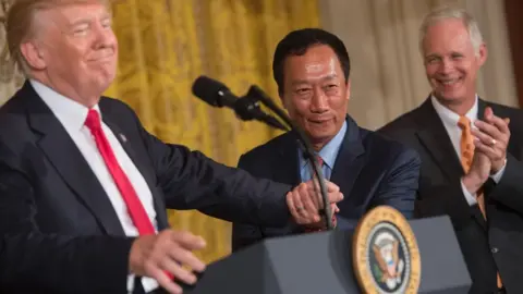 AFP/Getty Donald Trump shakes hands with Terry Gou in July after announcing Foxconn's investment