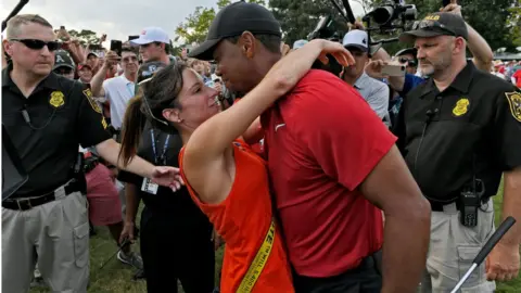 Getty Images Tiger Woods and Erica Herman celebrate after a golf event in 2018