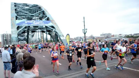 PA Media Runners cross the Tyne Bridge
