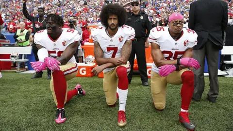 Getty Images Eli Harold, Colin Kaepernick and Eric Reid kneeling during the national anthem