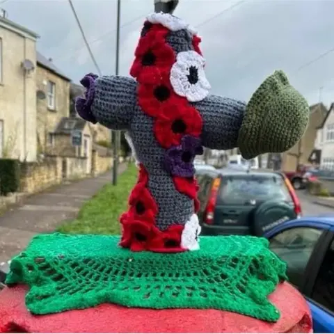 A remembrance day postbox topper with poppies