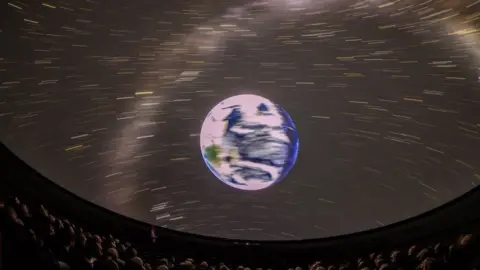 Martin Shields A picture from within a planetarium showing the earth and stars