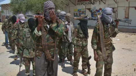 BBC Al-Qaeda linked al-shabab recruits walk down a street on March 5, 2012 in the Deniile district of Somali capital, Mogadishu