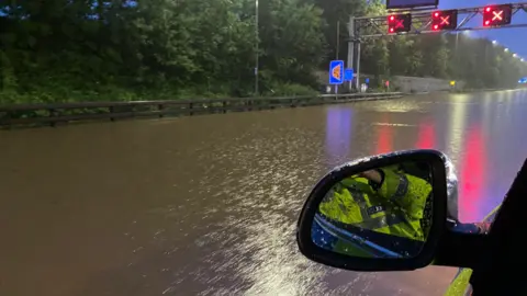 CMPG Flooded motorway seen from police car passenger window