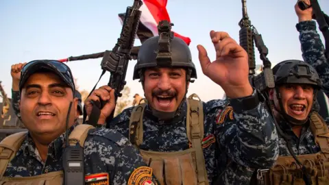 AFP Members of the Iraqi federal police celebrate in the Old City of Mosul on 10 July 2017