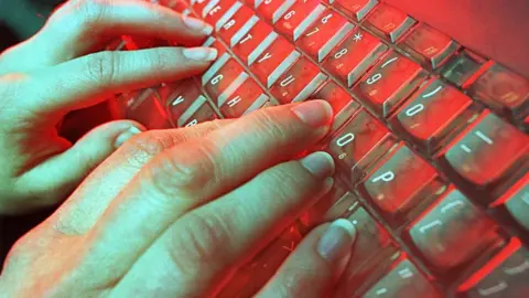 Getty Images File image of hands typing on keyboard