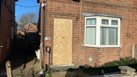 House with door boarded up