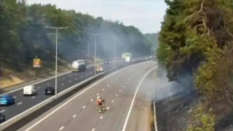 Two carriageways traveling northbound and southbound. the right hand side shows no cars at all, while the left hand side shows some cars driving down