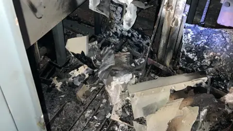 Machinery blackened by fire and no longer intact