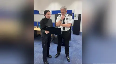 Thames Valley Police Temporary Assistant Chief Constable Olly Wright with an officer during a visit to the police station for the operation.