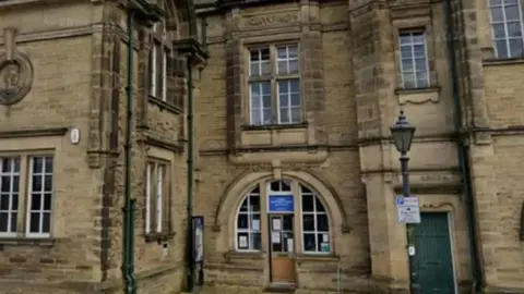 Victorian library building in brown stone with narrow windows