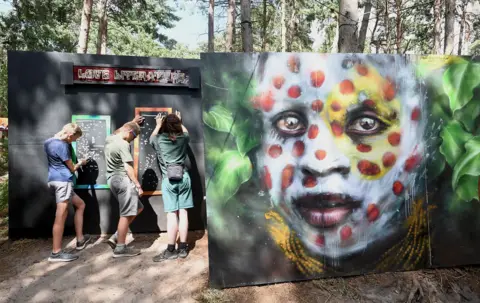 Getty Images Artwork by Dale Grimshaw on display performs during day four of Latitude Festival 2022 at Henham Park on July 24, 2022 in Southwold, England. 