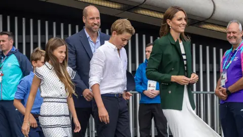 Prince William, Princess Catherine and their three children leave the Hydro in Glasgow. Commonwealth Games staff and volunteers line up to meet them