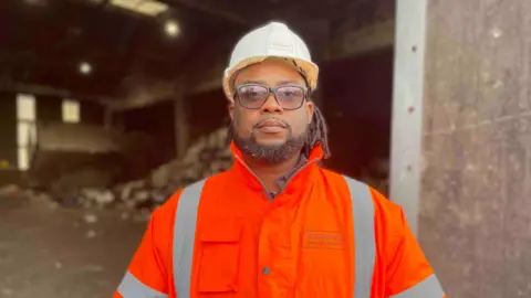 Councillor Ndukwe Onuoha wearing a hi-vis jacket
