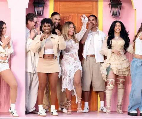 Getty Images for Roc Nation Karol G (centre) and Cardi B (right) among other people on stage smiling and dancing during the show.