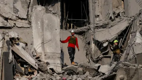 Emergency personnel work at an impacted residential site following a missile attack from Iran on Israel in Be'er Sheva, Israel on 24 June 2025.