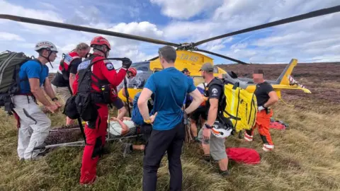 Edale Mountain Rescue Team Edale Mountain Rescue Team helps a runner on a stretcher on to an air ambulance in the southern edges of Kinder in Derbyshire.