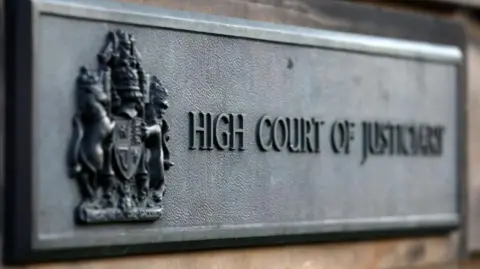 PA Media High Court in Edinburgh sign, text on rectangular gray sign says 'High Court of Justiciary'