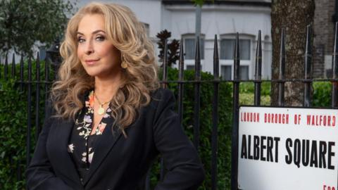 Tracy-Ann Oberman, standing by the famous Albert Square sign