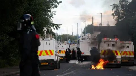 Large police presence and fire on road