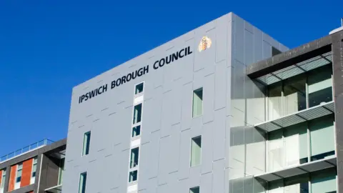 A large grey-stuccoed skyscraper with 'Ipswich Borough Council' written at the top. 