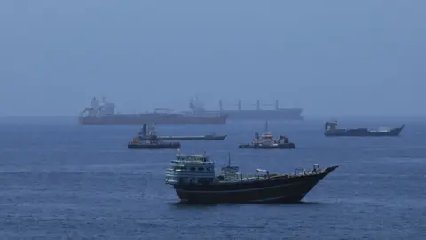 Ships in a body of water about to enter the Strait of Hormuz.