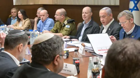 Israeli Government Press Office Prime Minister Benjamin Netanyahu (top row, second right) speaks during a meeting of the Israeli Security Cabinet in Jerusalem (17 January 2025)