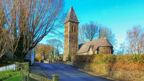 Bride Commissioners A church and tower in the village of Bride