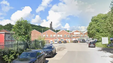 Cars parked in a quiet industrial estate on a sunny day