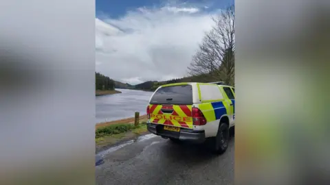 Police vehicle in front of water