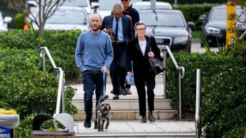 EPA Noel McLaughlin (L) and Elizabeth Young (R), husband and mother of victim Jade Young, arrive at the Lidcombe Coroners Court in Sydney