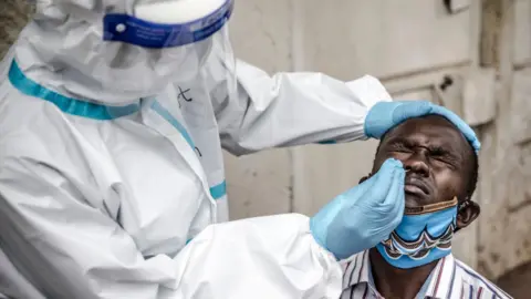 Getty Images Health worker collects a sample in Nairobi