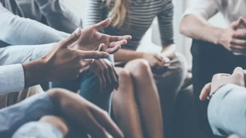 Getty Images Photo of group of anonymous people in a group setting